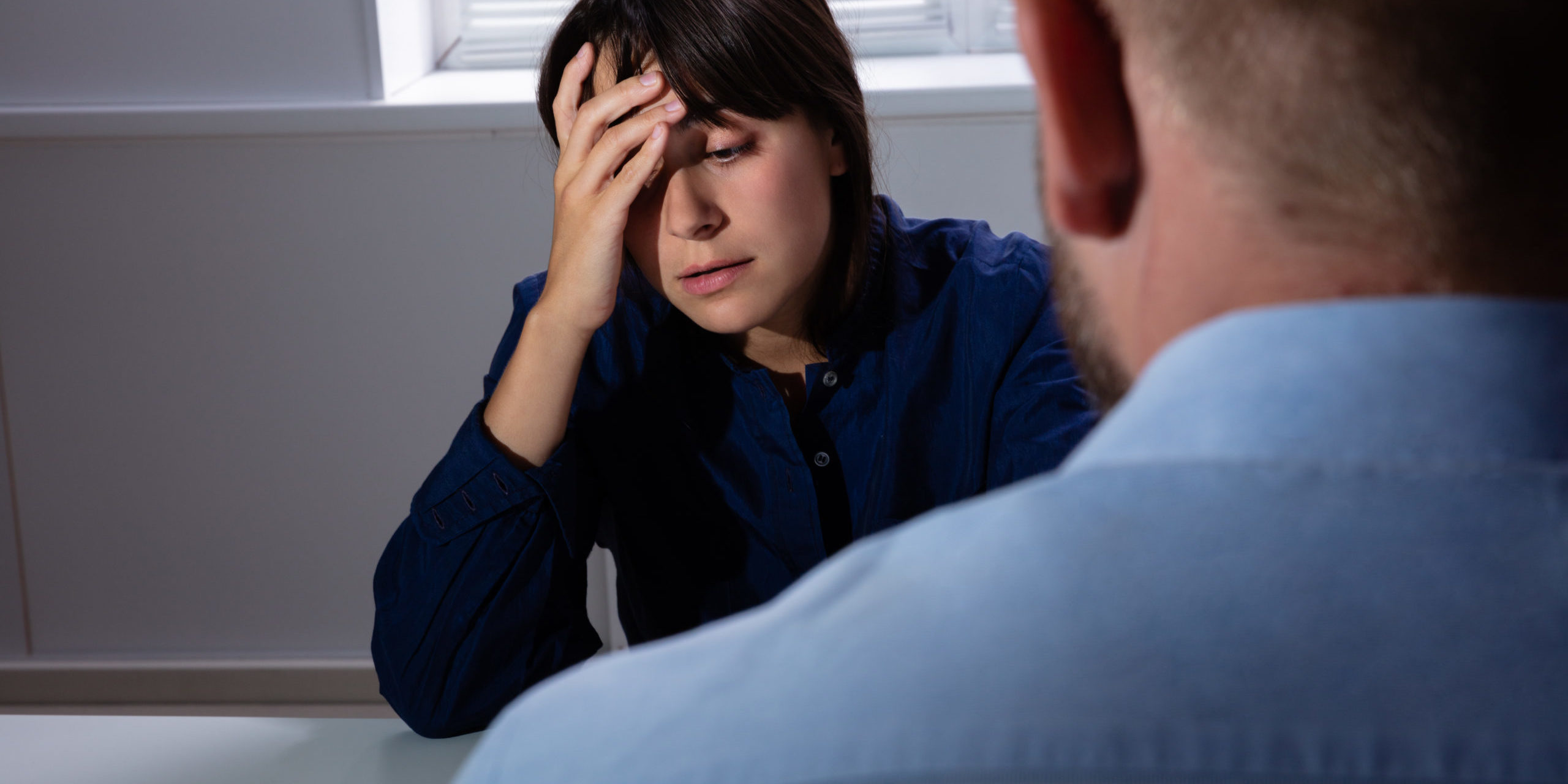 Close-up Of A Man Looking At Sad Woman In Room